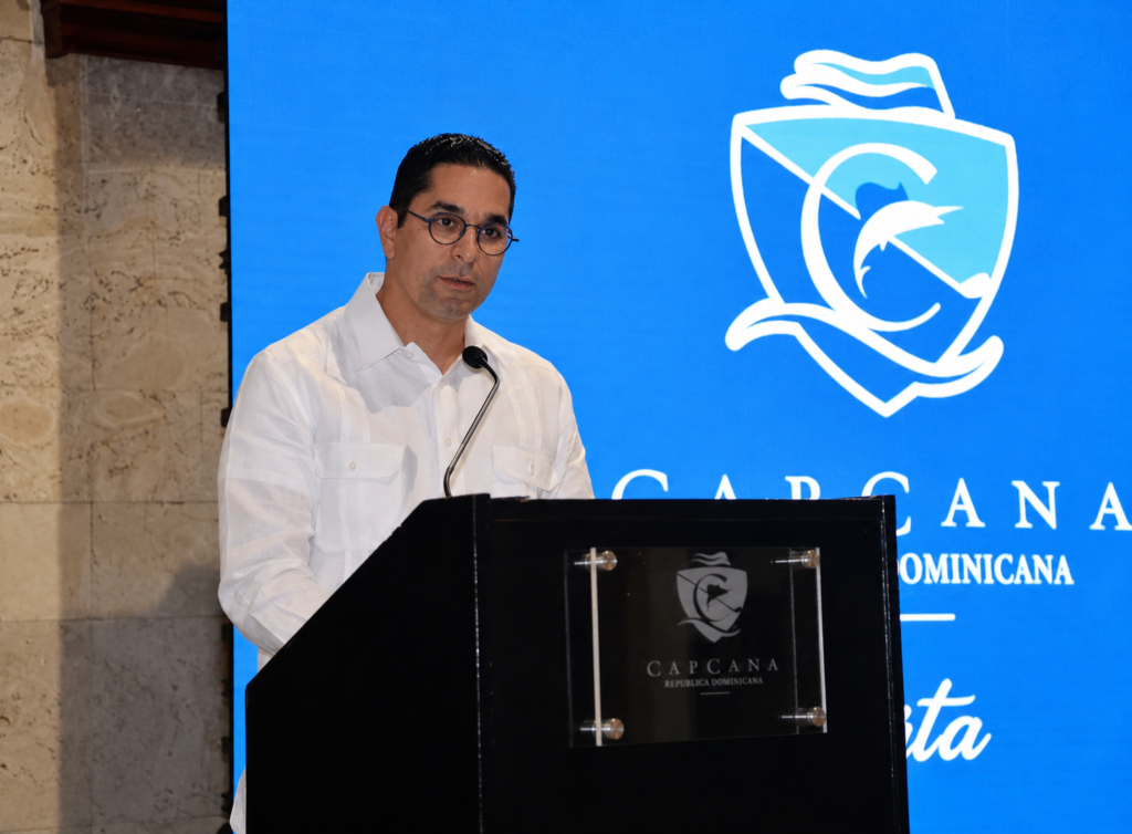 Jorge Subero, President of Cap Cana, speaking at a podium during a Cap Cana event in the Dominican Republic.